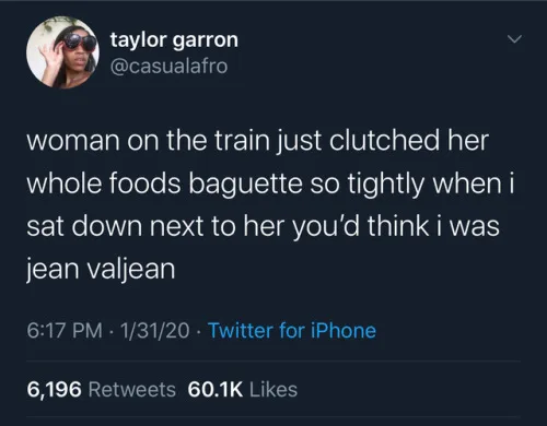 A screenshot of a tweet by Taylor Garron (@casualafro) showing a dark-mode Twitter interface. The tweet text reads: 'woman…