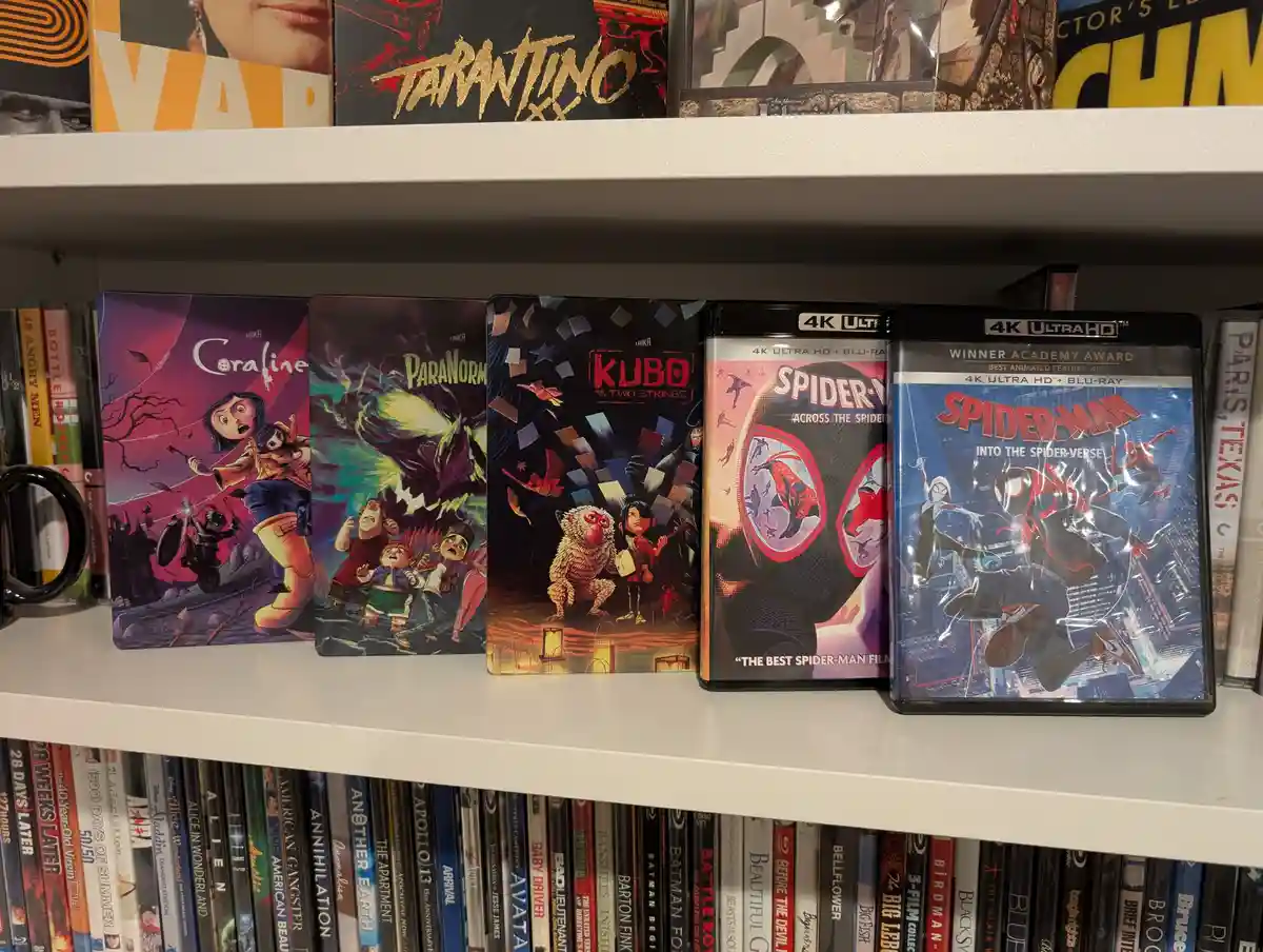 A shelf displays five 4K Ultra HD Blu-ray cases: 'Coraline', 'ParaNorman', 'Kubo and the Two Strings', 'Spider-Man: Across…