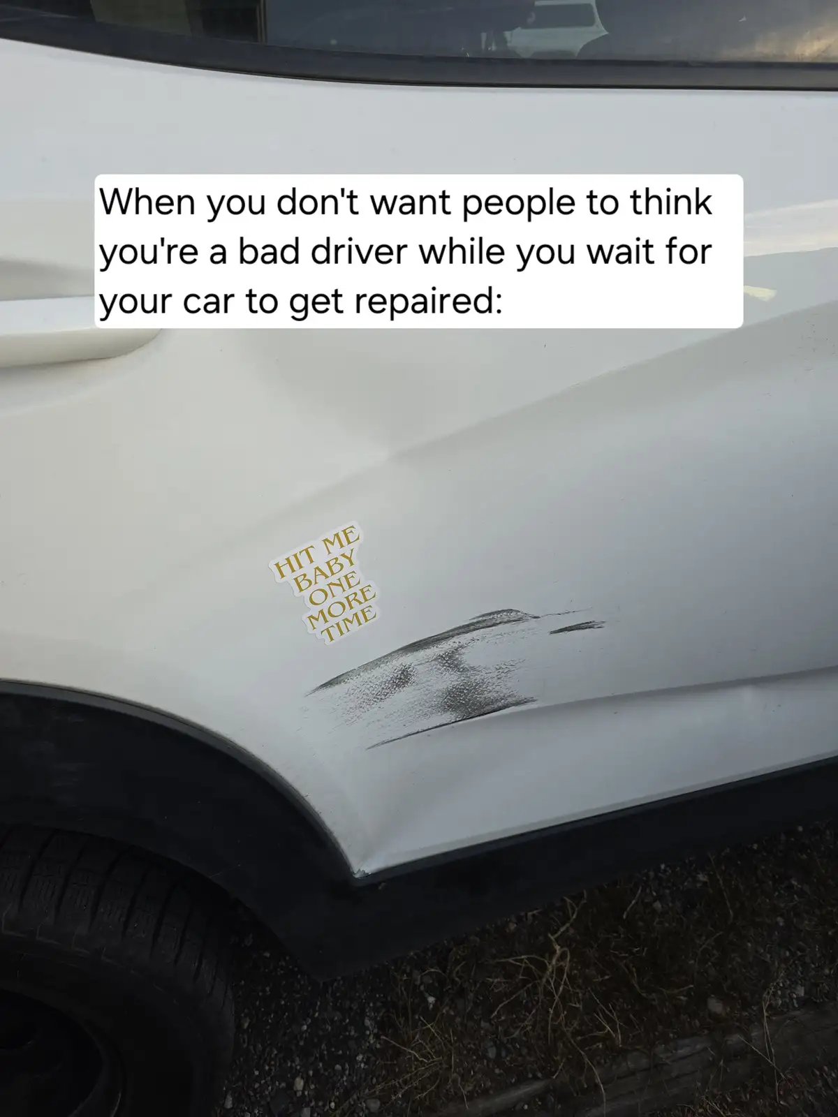 A close-up of a white car's side panel shows a noticeable dent and a sticker that reads 'HIT ME BABY ONE MORE TIME'. The…