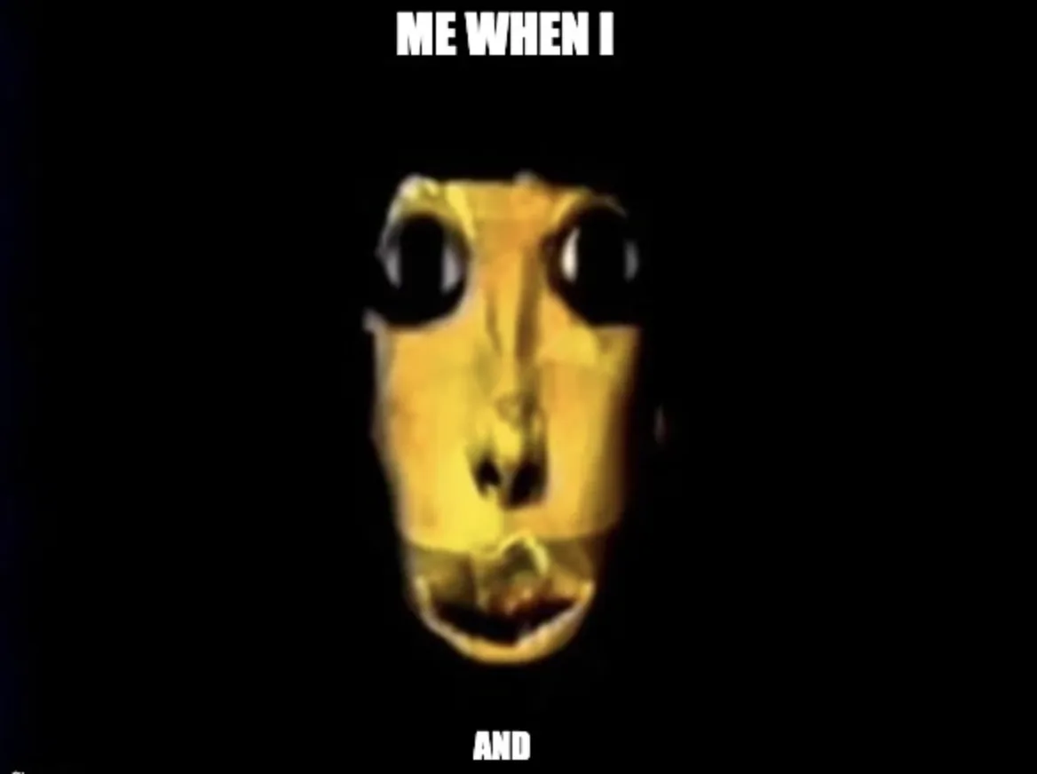 A blurry, yellow, alien-like face with large black eyes stares out from a dark background. White text at the top reads 'ME…