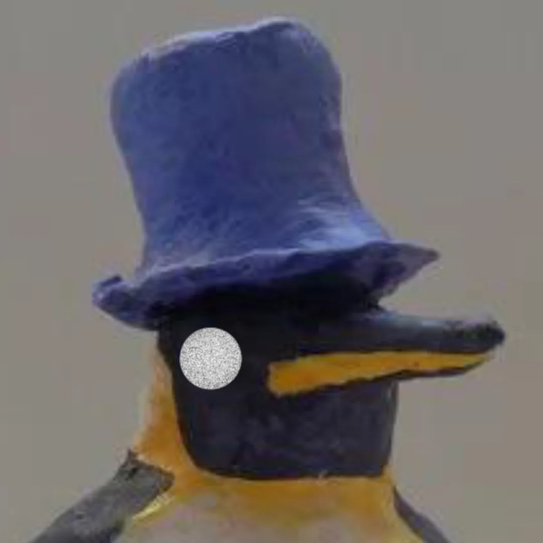 A close-up of a handmade penguin figurine wearing a blue top hat, with its right eye replaced by a glittery white circle…