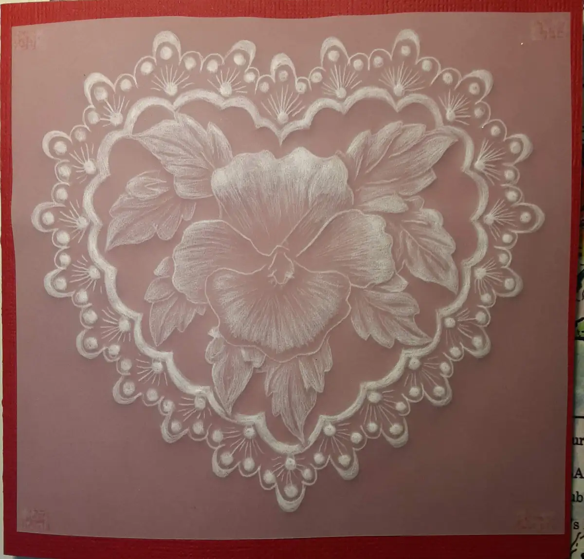 A detailed white chalk drawing on pink paper depicts a large central flower surrounded by leaves and an ornate, scalloped…