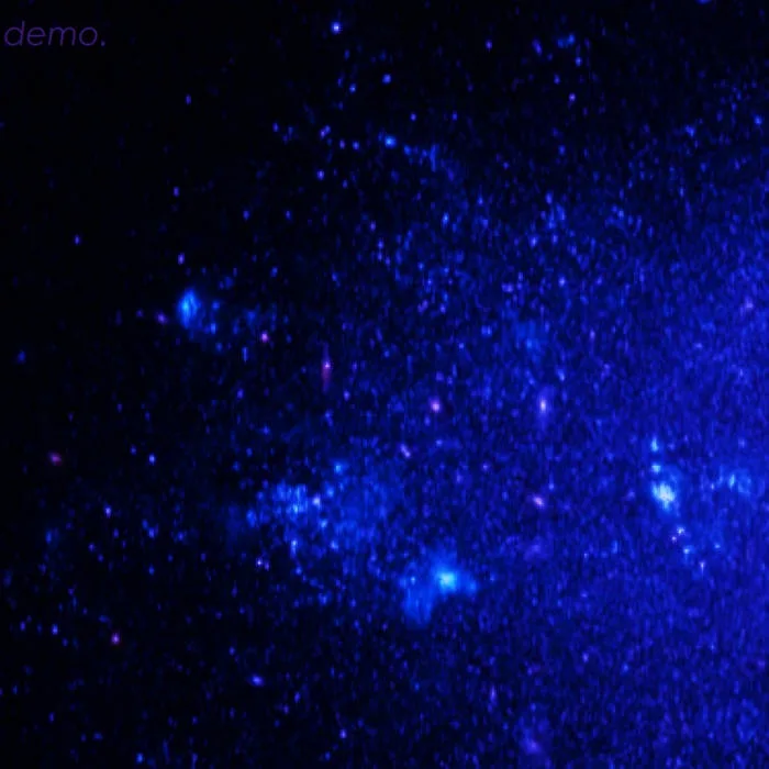 A dark blue cosmic image filled with numerous bright blue and purple specks resembling stars or distant galaxies, with the…