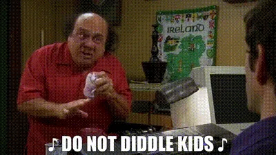 A still from the TV show 'The Office' shows a man in a red shirt holding a crumpled white object while speaking emphatically…