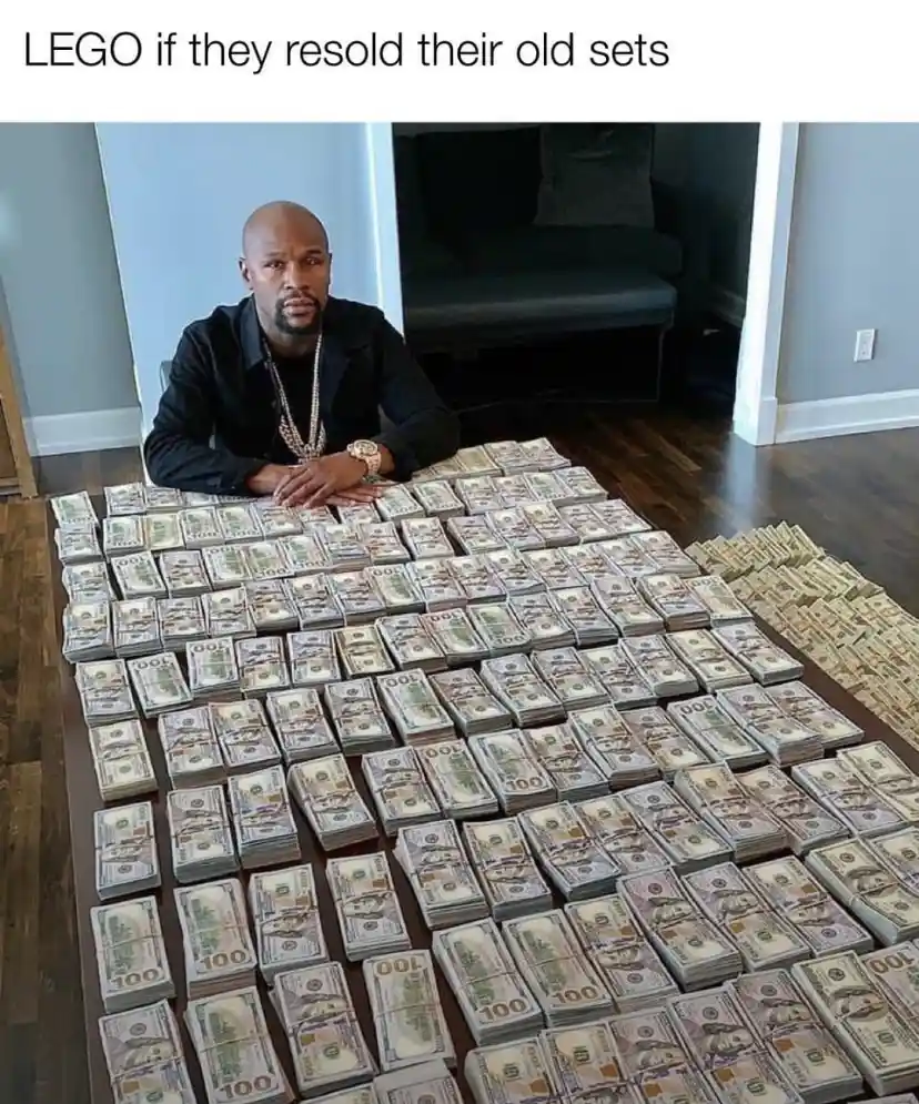 A man sits at a table covered with hundreds of stacks of US $100 bills, looking serious. The text overlay reads 'LEGO if…