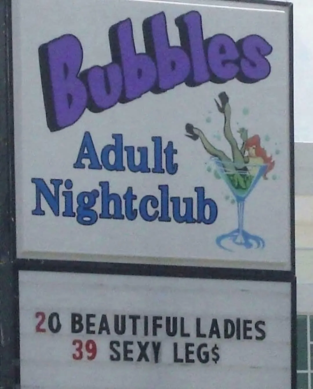 A sign for 'Bubbles Adult Nightclub' features a cartoon woman in a martini glass. Below, a marquee reads '20 BEAUTIFUL…