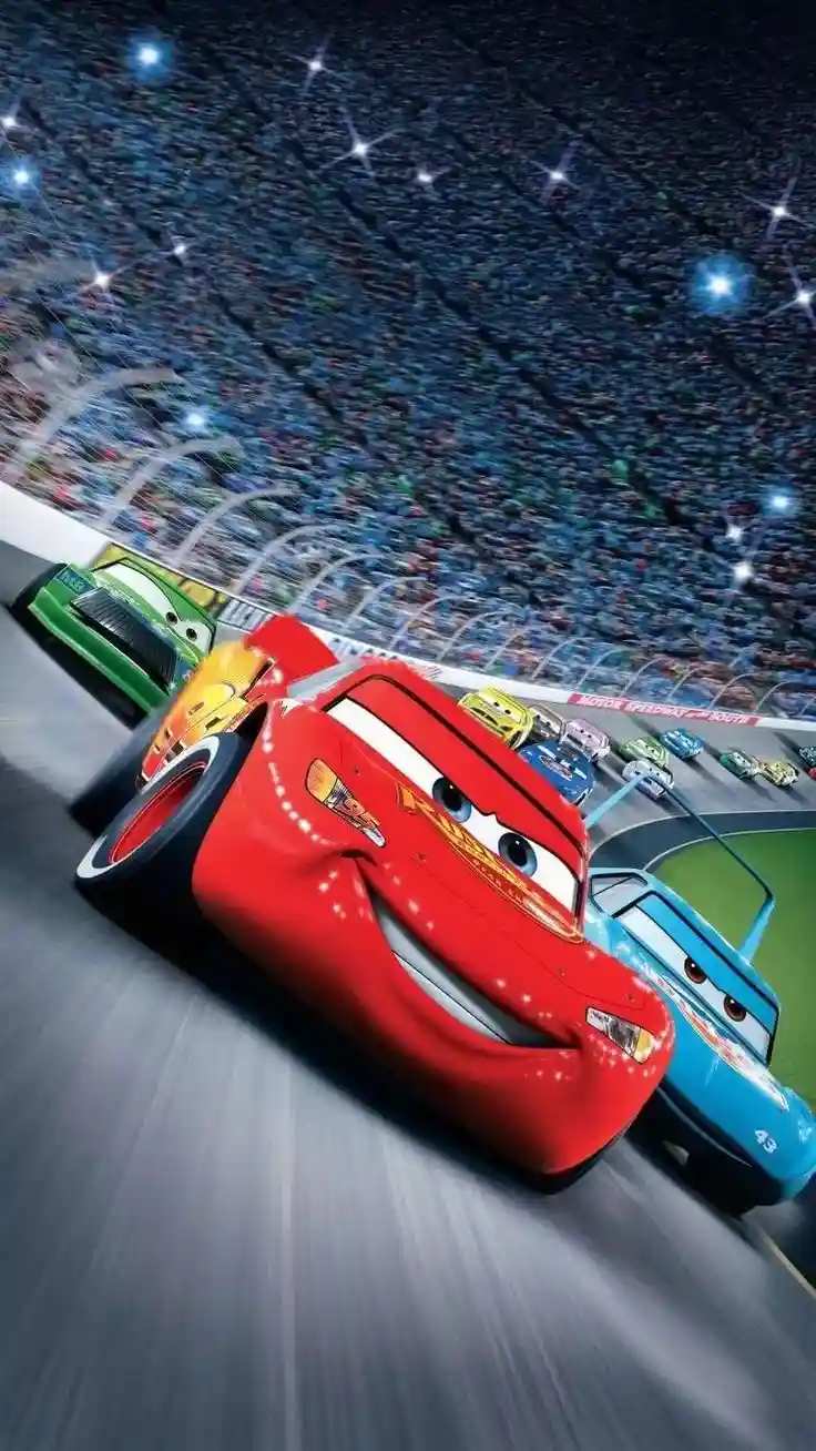 A dynamic, low-angle shot from the animated movie 'Cars' shows the red race car Lightning McQueen leading a pack of…