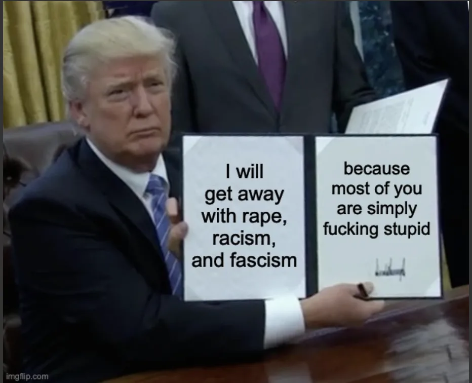 A man in a suit sits at a desk holding two white cards. The left card reads 'I will get away with rape, racism, and fascism'…