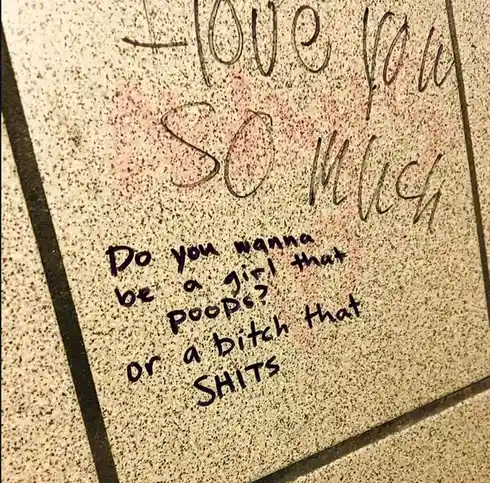 A close-up of a speckled beige tile floor with handwritten text in black marker. The top line reads 'I love you so much'…