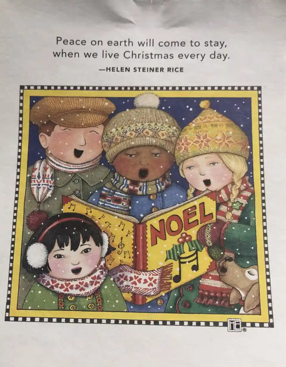 A festive illustration shows four children in winter hats and scarves singing from a book titled 'NOEL' under falling snow…
