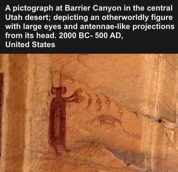 An ancient rock painting in Barrier Canyon, Utah, shows a humanoid figure with large circular eyes and antenna-like…