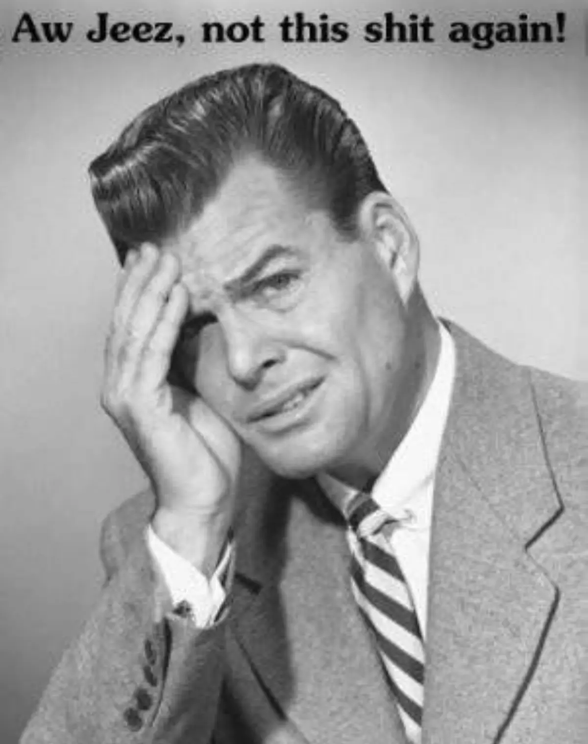 A black-and-white photo of a man in a suit and striped tie, looking exasperated with his hand on his forehead. The text…