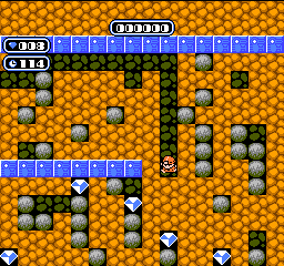 A pixelated screenshot from a classic 8-bit video game, likely Super Mario Bros., showing Mario standing on a brown, rocky…