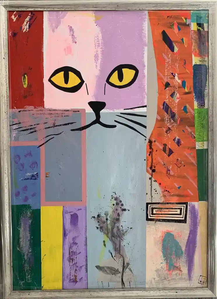A colorful abstract painting of a cat's face with yellow eyes and black whiskers, set against a collage of vibrant geometric…