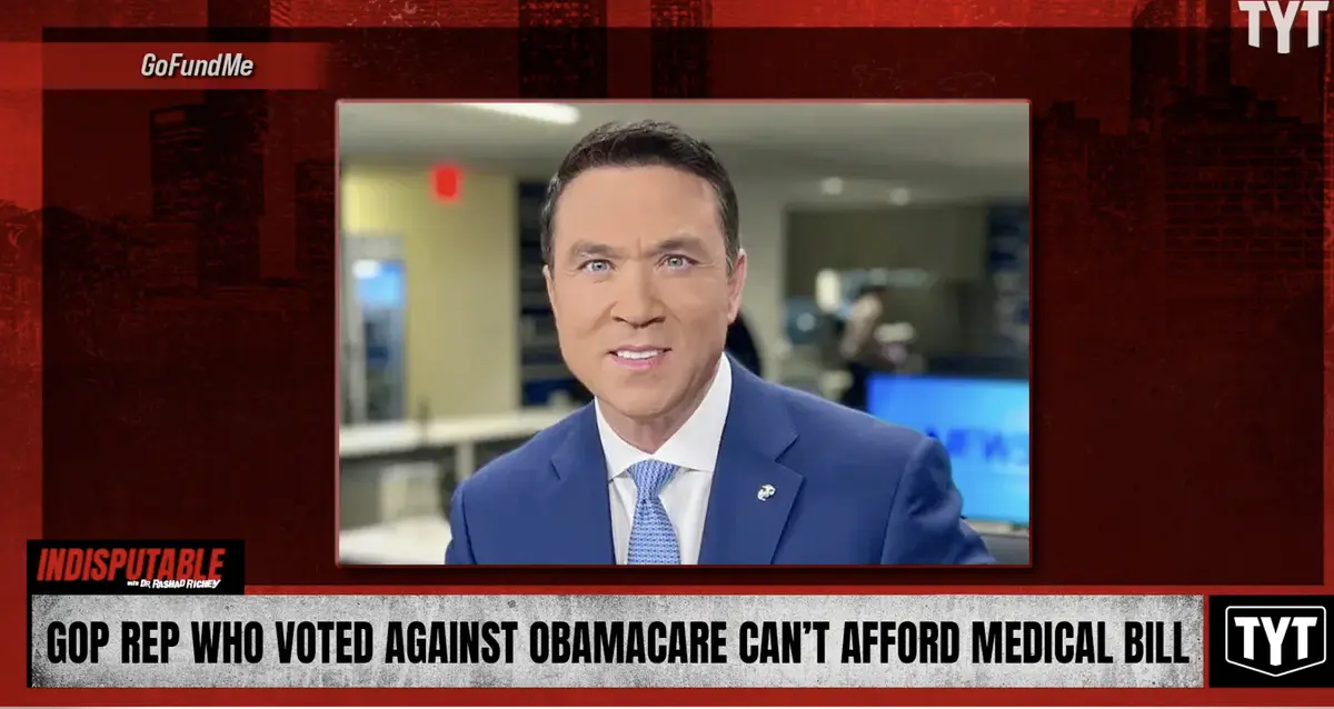 A screenshot from a TYT News segment titled 'INDISPUTABLE with Dr. Rashad Richey' shows a man in a blue suit and tie with a…