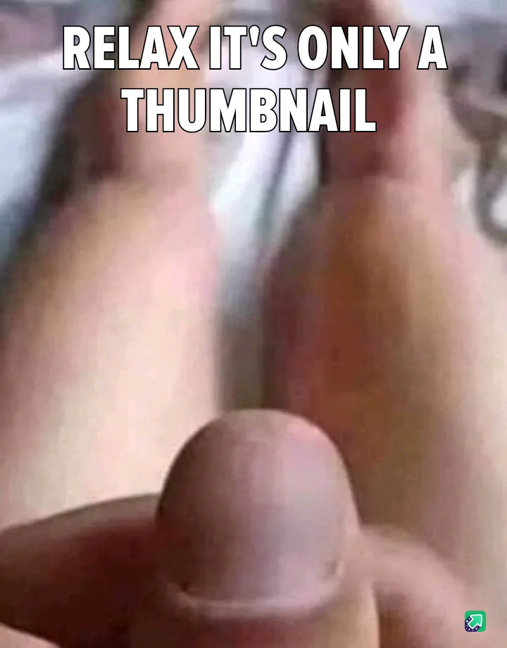 A close-up, blurry image shows a human thumb prominently in the foreground, with out-of-focus fingers and skin in the…