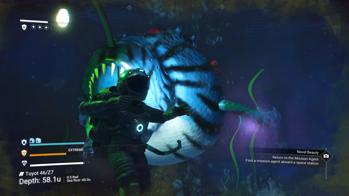 A player in a diving suit stands calmly in front of a massive, glowing, toothy fish in a dark underwater environment. The…