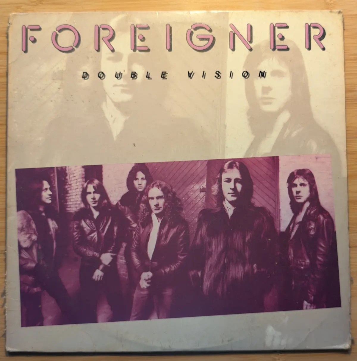 The image shows the cover of the 1981 album 'Double Vision' by the rock band Foreigner. The cover features a faded…