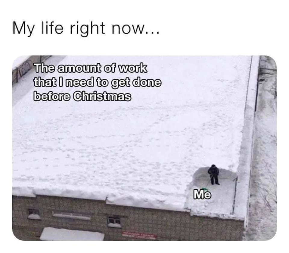 An aerial photo shows a person in dark clothing standing on a snow-covered roof, holding a snow shovel. The person is…