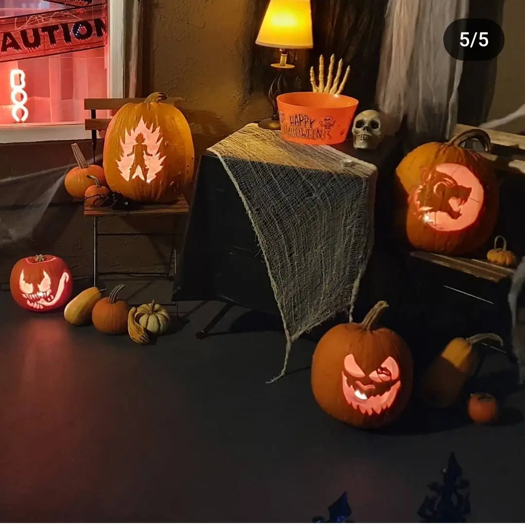 A dimly lit Halloween scene features multiple carved pumpkins with glowing designs, including a character resembling Goku…