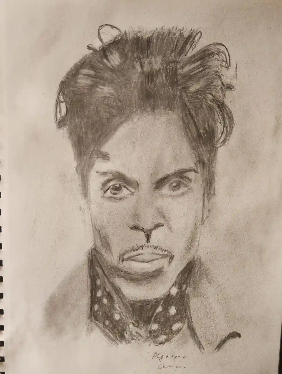 A pencil sketch of Prince, drawn on spiral-bound paper, shows him with his signature hairstyle and a polka-dot collar. The…