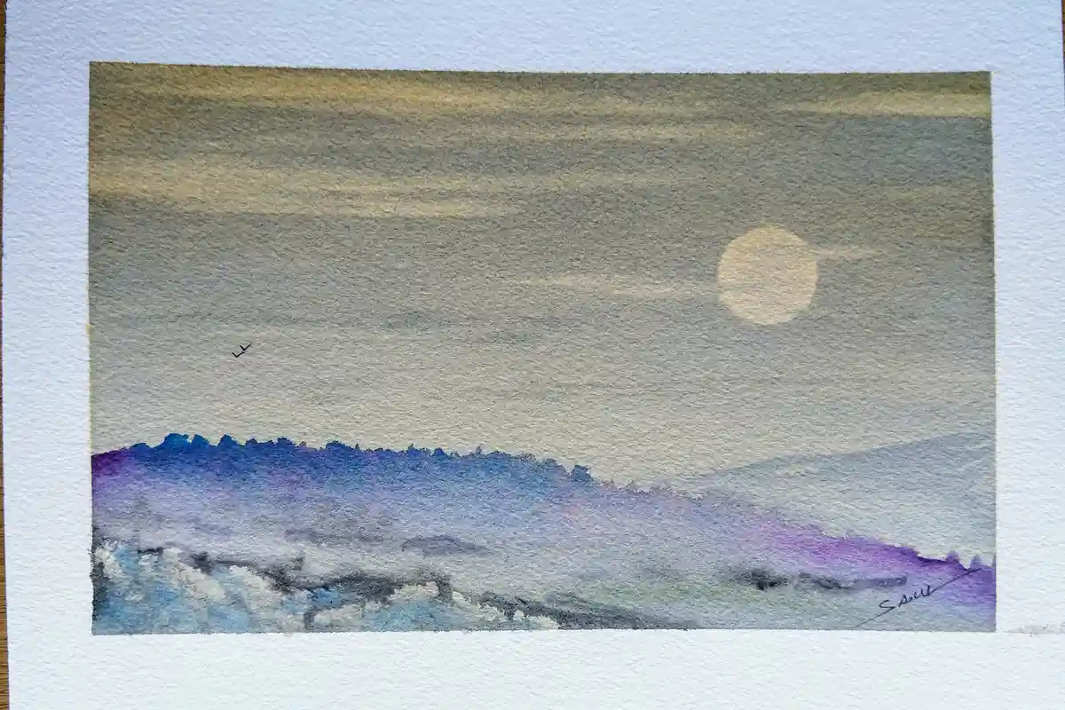 A watercolor painting depicts a serene landscape with a large, pale yellow moon in the sky, a small black bird silhouette…