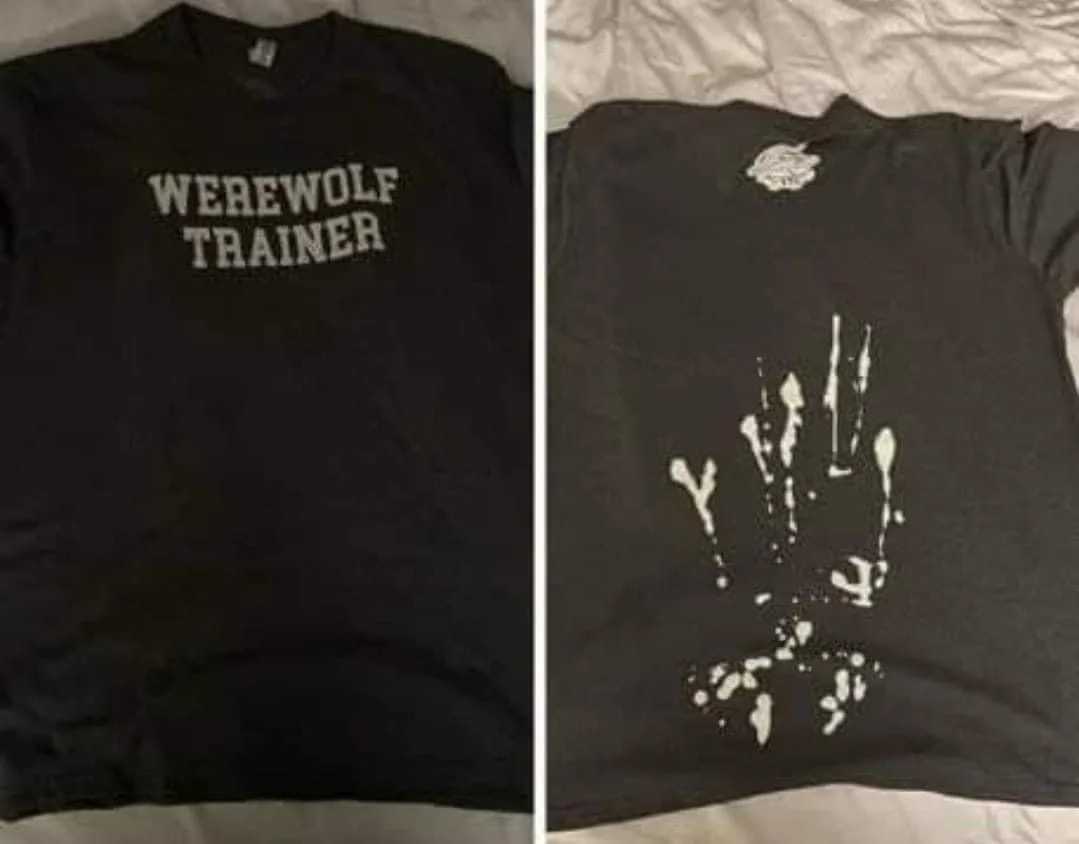 A split image shows a black t-shirt with 'WEREWOLF TRAINER' printed in white block letters on the front, and the back of the…