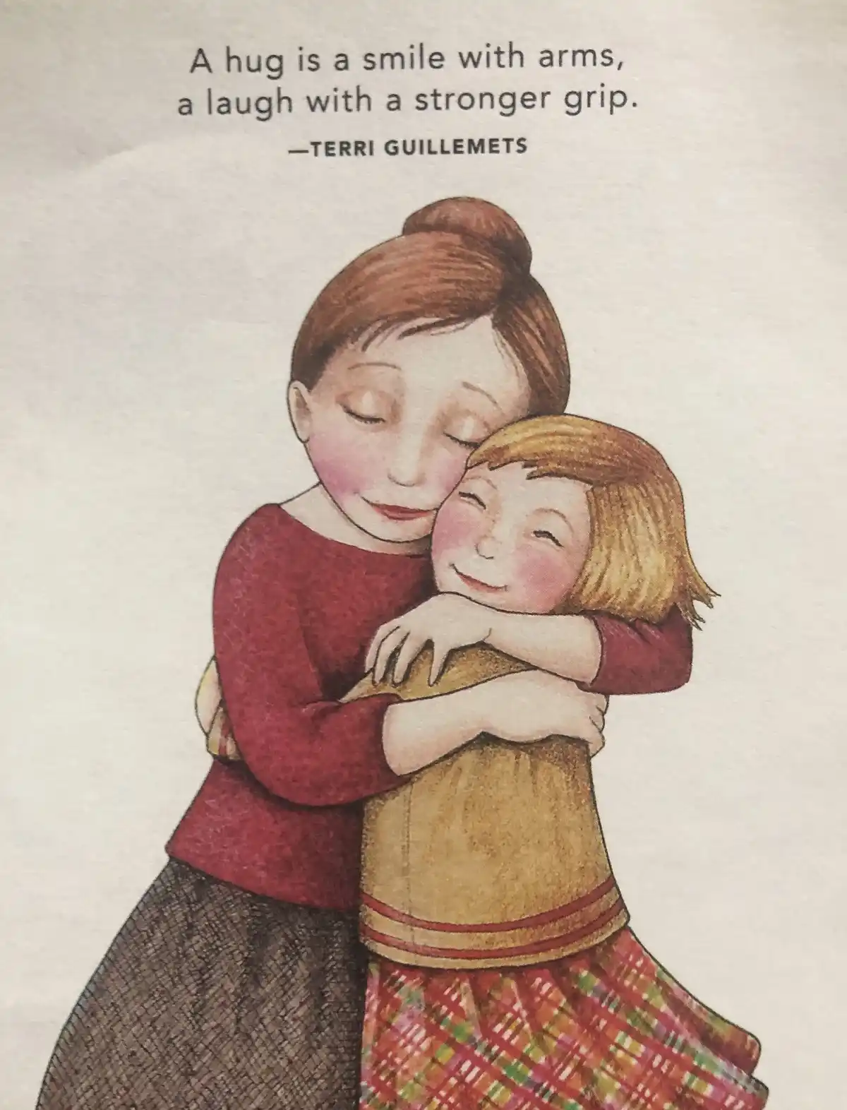 An illustration shows two girls warmly embracing each other; the taller girl with brown hair in a bun wears a red top and…