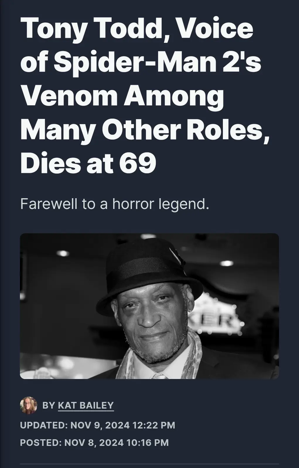 A black and white photo of actor Tony Todd wearing a fedora, suit, and scarf, overlaid with a news-style headline announcing…