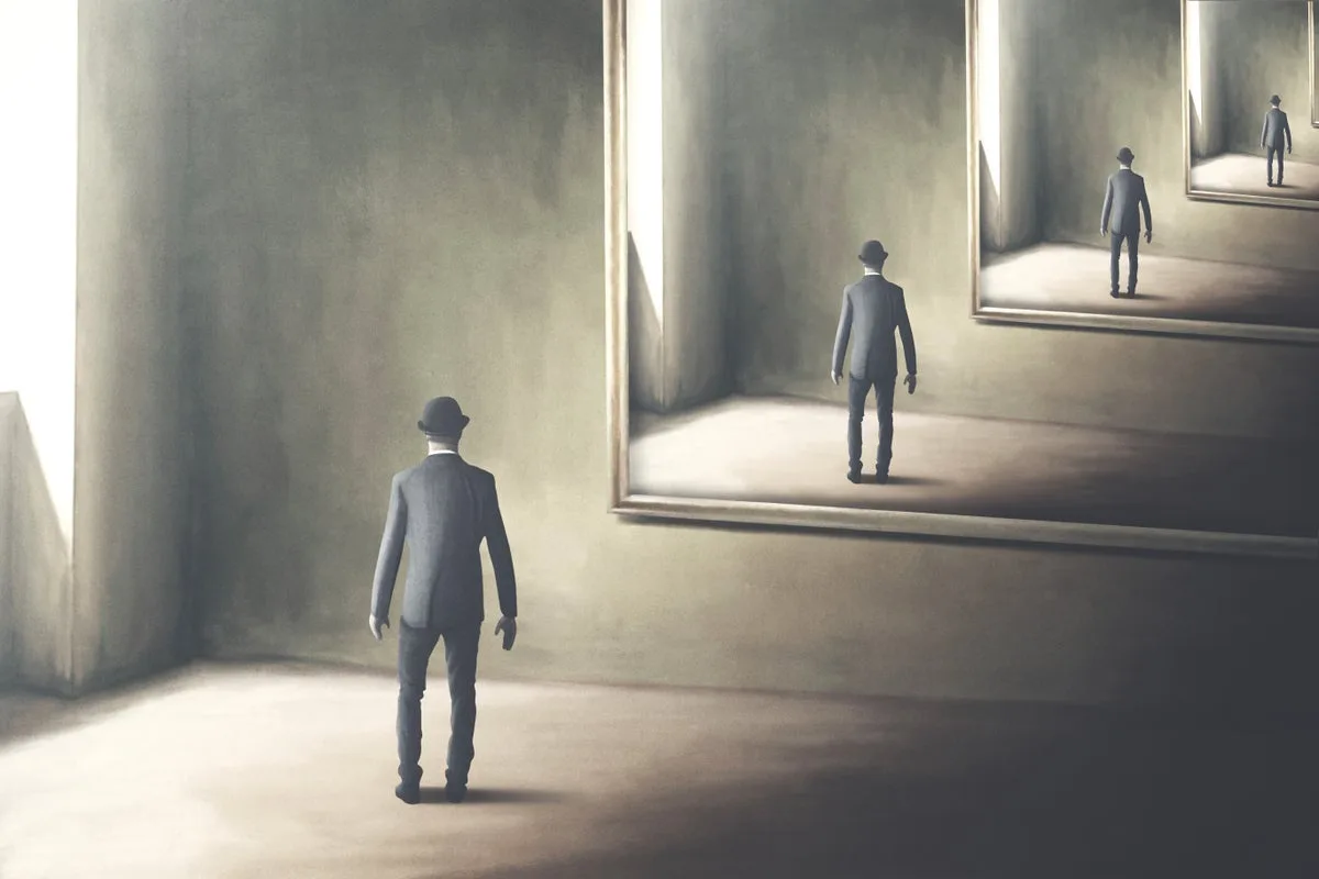 A man in a suit and bowler hat stands in a dimly lit room, looking at a large framed painting that depicts him standing in…