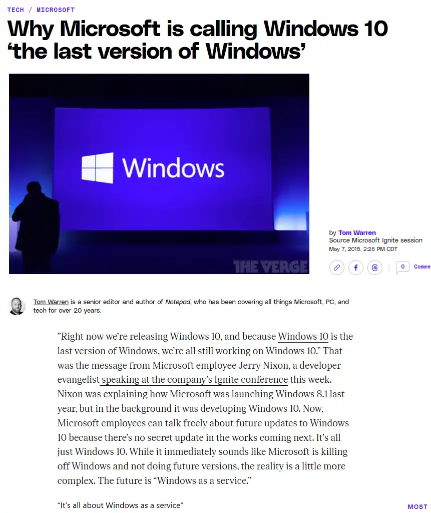 A screenshot of a The Verge article from May 7, 2015, showing a large screen with the Windows logo and text. A person's…