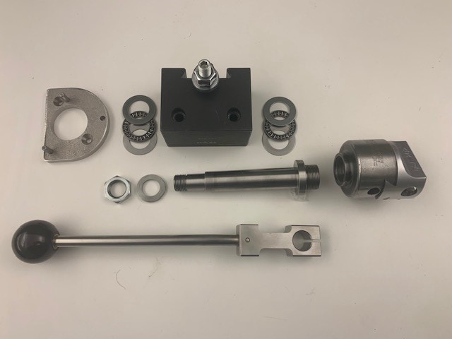 a flat-lay photo of various mechanical parts including a ball handle, bearings, a black block, and metal brackets arranged…