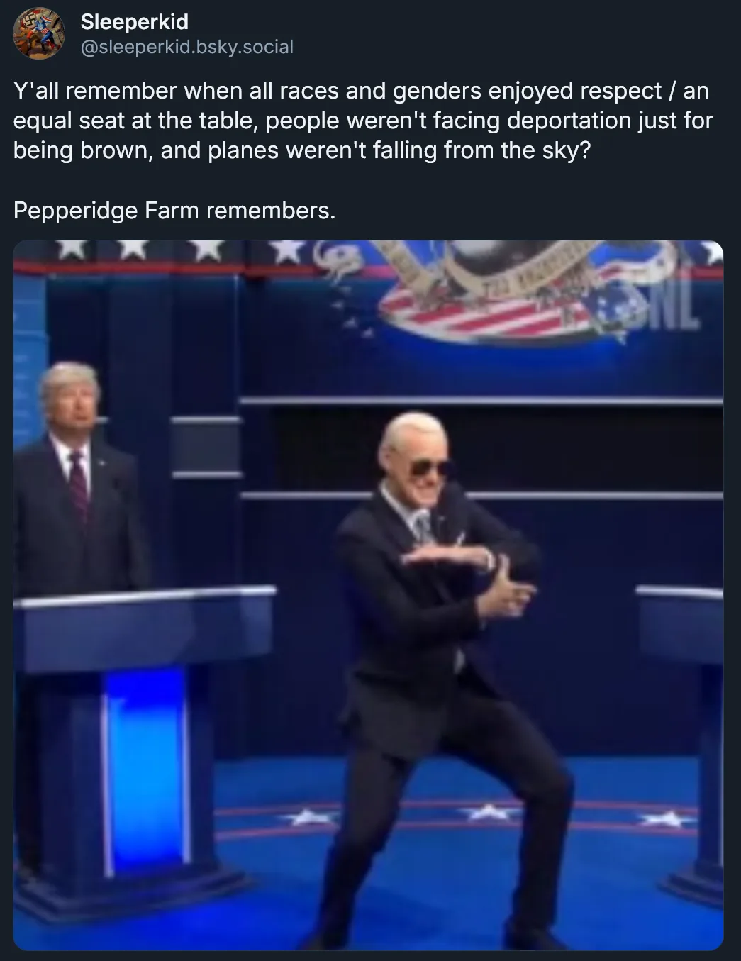 A still image from a political debate shows a man in a suit and sunglasses performing a dance move while another man stands…