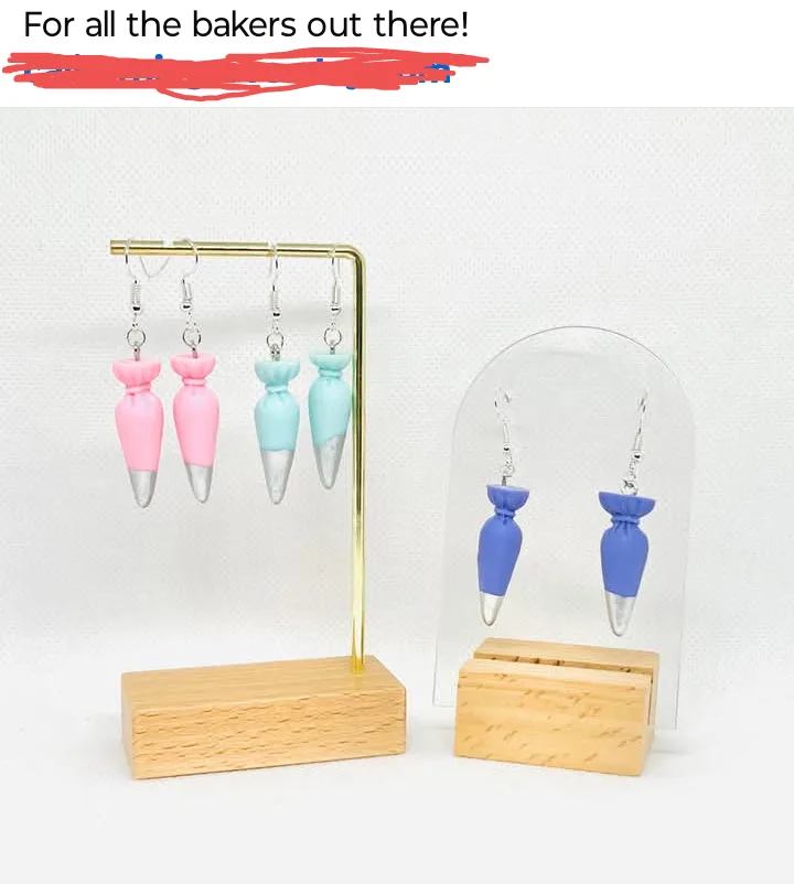 A product photo shows two sets of earrings shaped like piping bags used in baking, displayed on wooden stands with clear…