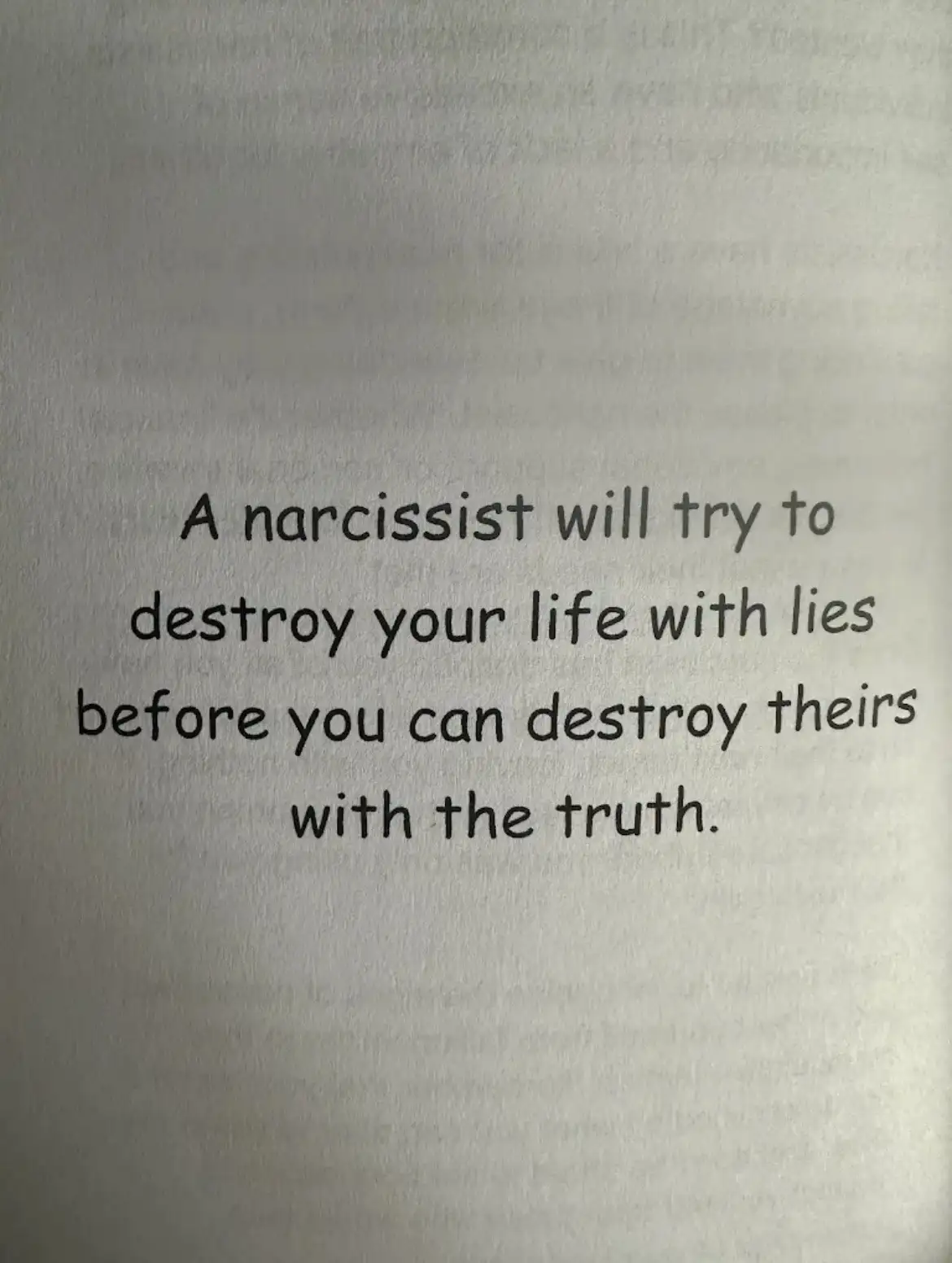 The image shows a close-up of printed text on textured white paper. The text, in a simple black font, reads: 'A narcissist…