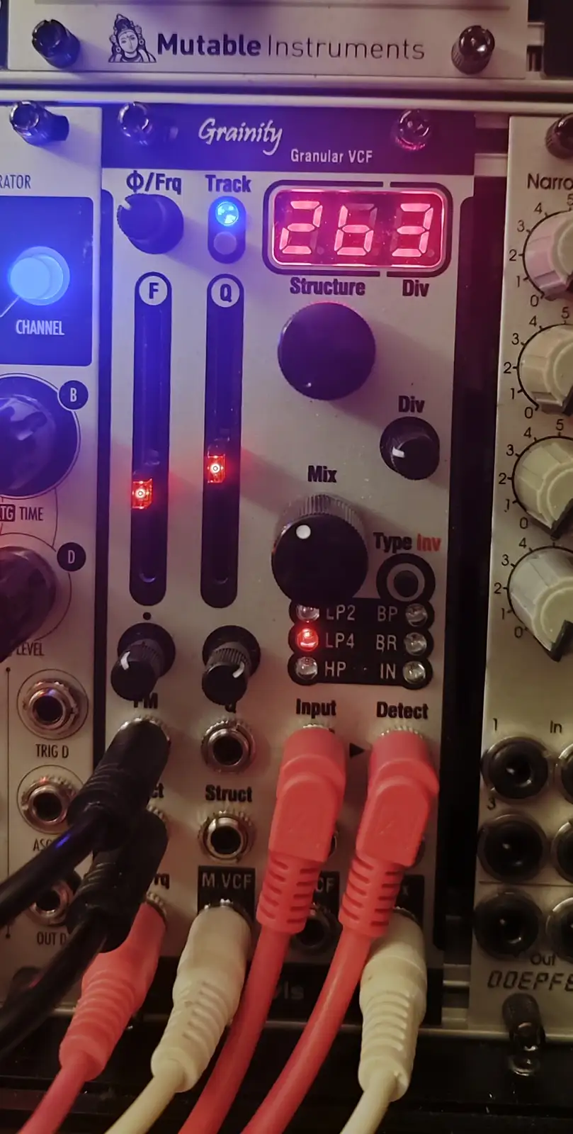 A close-up of a Mutable Instruments Grainity granular VCF synthesizer module with its red LED display showing the number…