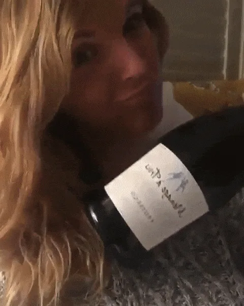 A woman with long blonde hair is shown in a six-panel grid. In the first five panels, she holds a wine bottle, smiling and…