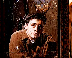 A six-panel image grid shows actor John Krasinski in a brown jacket, looking increasingly distressed and sweating as he…