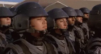 Six panels from the movie 'Starship Troopers' show soldiers in uniform and helmets. The first panel shows a line of soldiers…