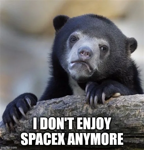 A black bear with a sad, disappointed facial expression rests its paws on a log. White bold text overlaid at the bottom…