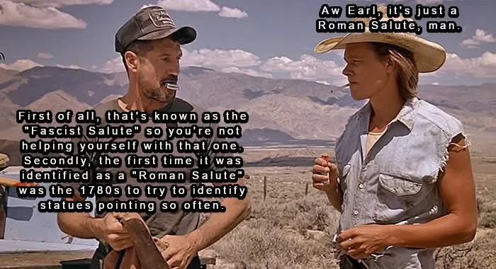 Two men stand in a desert landscape with mountains in the background. The man on the left, wearing a cap and holding a tool…