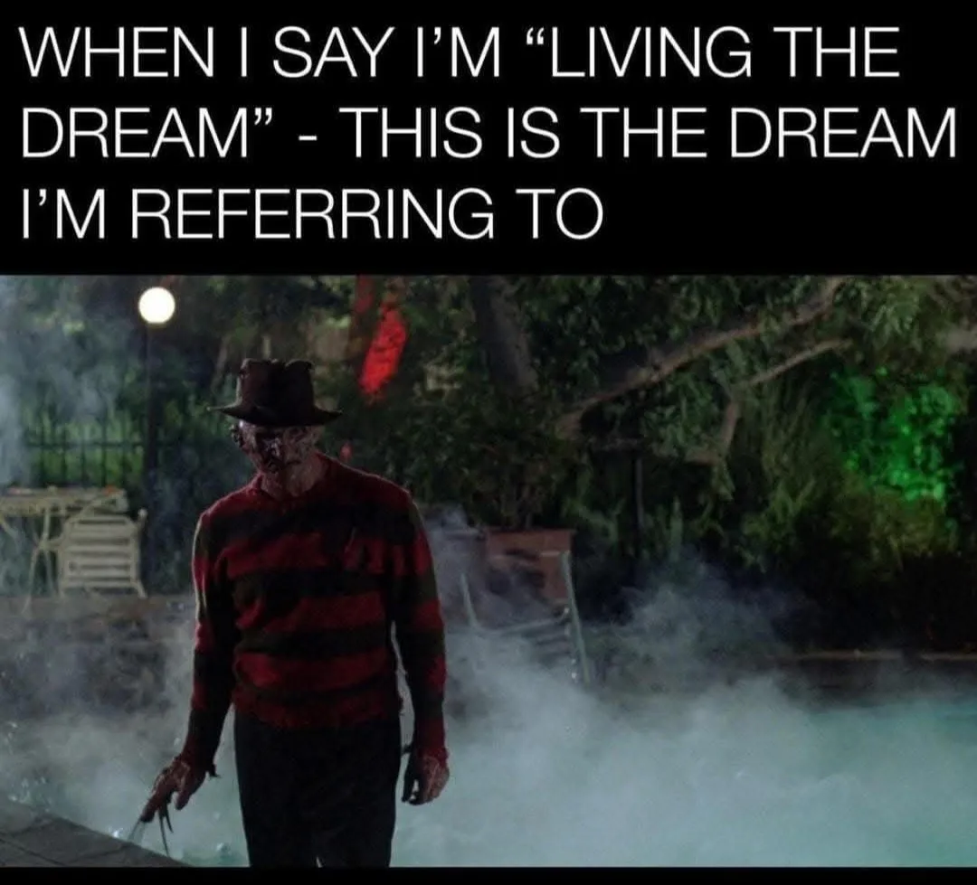 A still image of the horror movie character Freddy Krueger, wearing his iconic red and black striped sweater and brown…
