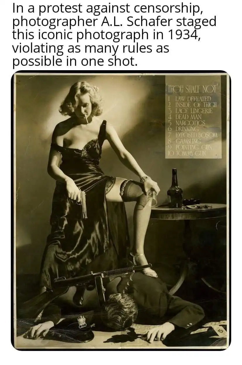 A vintage black-and-white photograph shows a woman in a revealing satin dress and stockings, smoking a cigarette while…