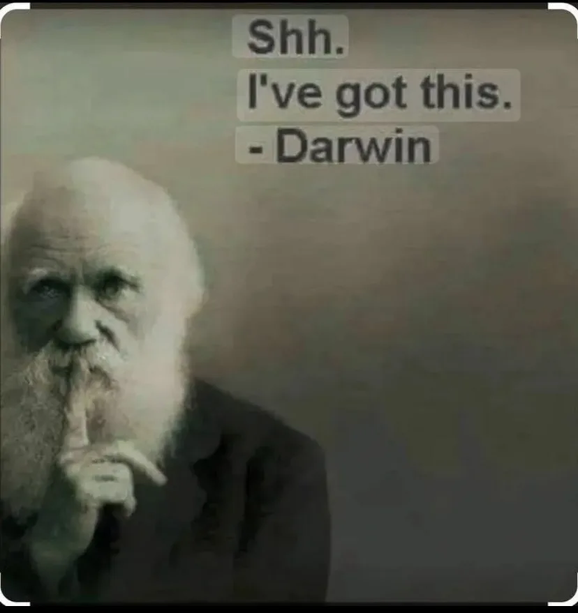 A sepia-toned portrait of Charles Darwin with his finger pressed to his lips in a 'shushing' gesture, overlaid with the text…