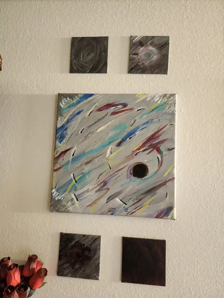 A wall displays five small paintings: two dark abstract squares at the top, a large central abstract painting with colorful…