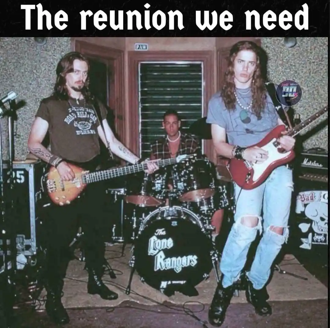 Three men in 1990s grunge attire pose with guitars and drums; the bassist wears a 'Road Kill Cafe' shirt, the drummer sits…