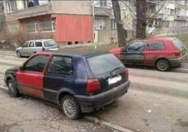 two cars parked on a street, each painted half red and half blue, with a building and trees in the background. the overlaid…