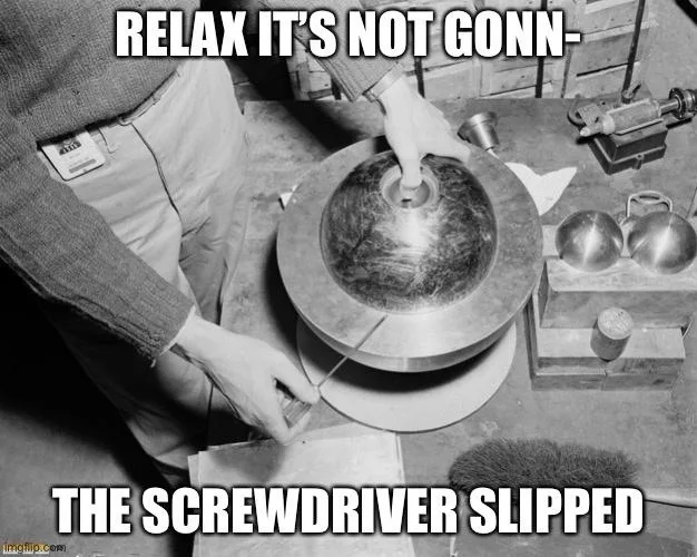 A black and white photo shows a person in a workshop, holding a screwdriver against a large metal dome. The person's other…
