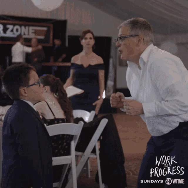 A six-panel sequence from the TV show 'Work Progress' shows a man in a white shirt and glasses standing up and shouting…