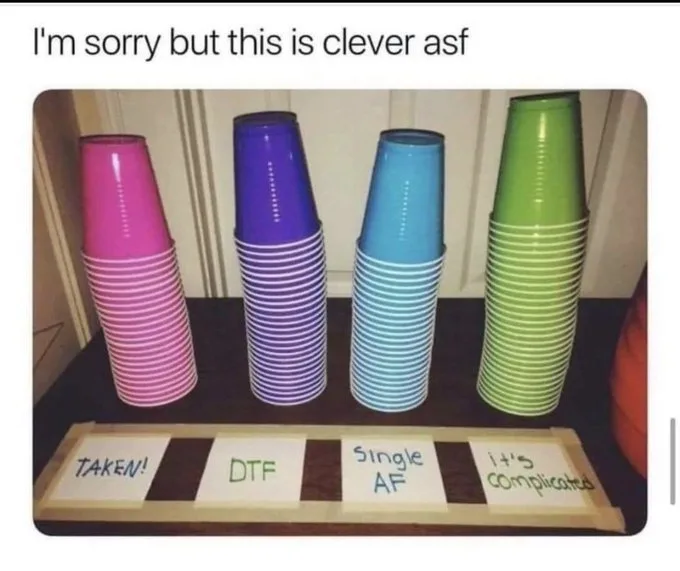 Four stacks of colorful plastic cups are arranged on a table, each labeled with a different dating status: 'TAKEN!', 'DTF'…